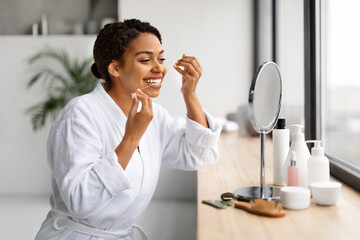 Oral Care. Happy Black Female Looking In Mirror And Using Dental Floss - obrazy, fototapety, plakaty