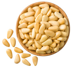Roasted pine nuts in the wooden bowl,a isolated on the white background, top view.