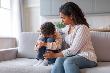 Caring African American Mom Comforting Upset Little Son At Home, - Powered by Adobe