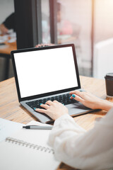 Close-up back view of a business woman working in the office typing, looking at the screen. office worker using a notebook computer..