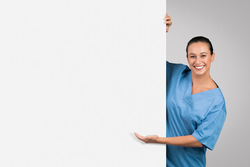 Smiling female nurse with blank banner for text