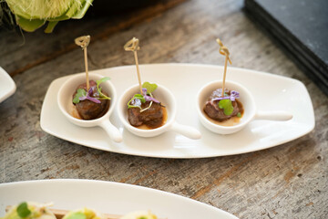 three small pieces of steak with peruvian seasoning called lomo saltado as appetizers at latin restaurant