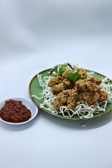ayam goreng kering is an indonesian food crispy fried chicken with hot and spicy sambal chili sauce. delicious homemade crispy fried chicken. crunchy fried chicken ready to eat.