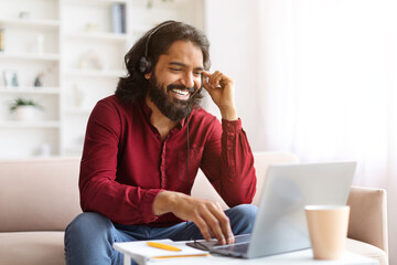 Indian man have online meeting with colleagues, working from home