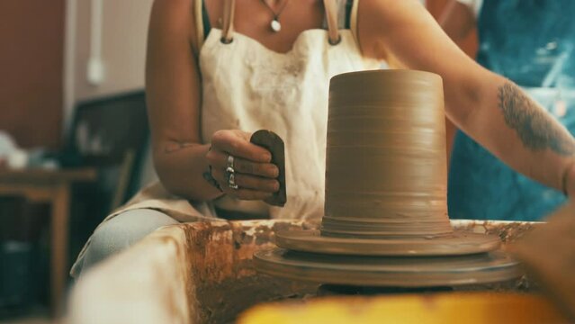 Woman, hands and clay cylinder for pottery, ceramics or mold in creativity, art or shape at workshop. Closeup of female person, sculptor or artist working on pot sculpture, craft or handmade startup