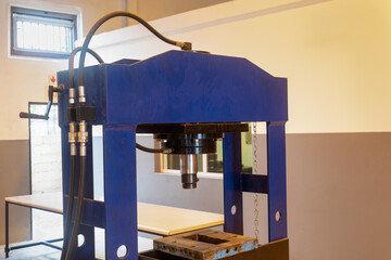 industrial hydraulic press medium size, in an workshop, small business entrepreneur