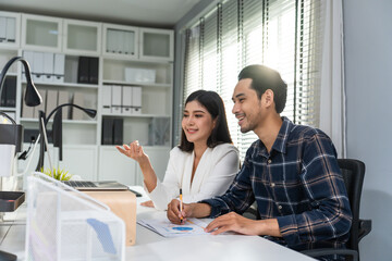 Asian young businessman and businesswoman people working in office.