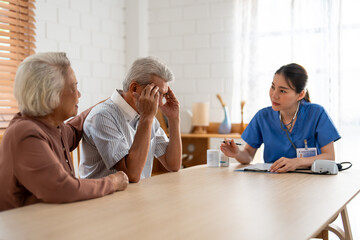 Asian caregiver nurse examine senior male patient and his wife at home. - obrazy, fototapety, plakaty