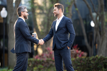 Businessman handshake for teamwork ,successful. Business network concept. Management strategy. Human resources. businessman greeting and making handshake with a businessman outdoors in city walkway.