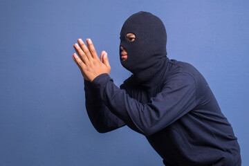 Male thief wearing black balaclava gets caught stealing and beg for forgiveness