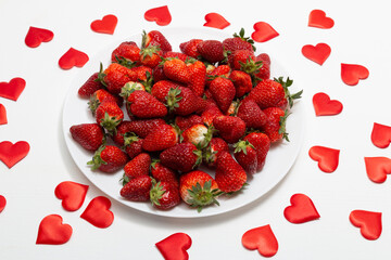 Strawberries in heart bowl - Valentine's Day. Flat lay with copy space