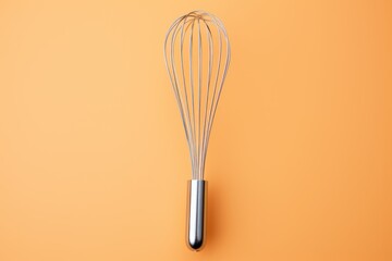 Metal whisk on color background, top view