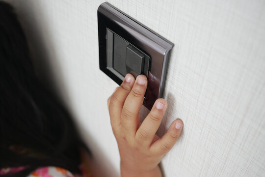  child finger turning on lighting switch with copyspace 
