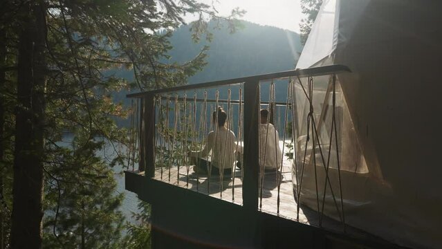 Lovers of yoga connect with nature at gambling. Couple embraces sunrise meditation practice attuning to gentle serenity of morning. Spiritual growth