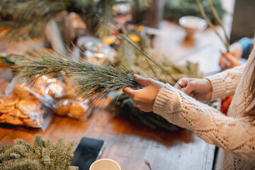 Actively involved in a workshop, a young lady creates handmade Christmas ornaments.