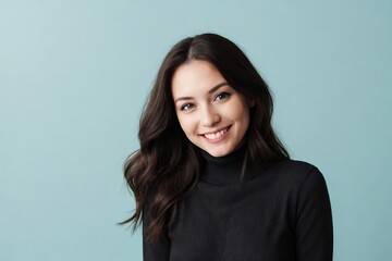 Fototapeta premium Attractive woman wearing a black turtleneck sweater is standing against the blue background with copy space.