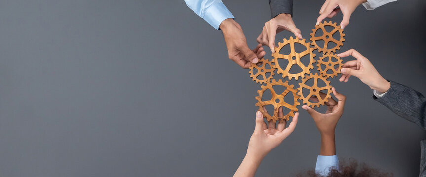 Panoramic shot top view of business people holding cog wheel as unity and teamwork in corporate workplace concept. Office worker colleague with symbol of visionary system for business success. Concord