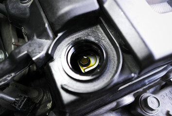 Close up inside a engine oil filler vent of a car engine in engine compartment , Car maintenance...