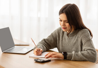 Young woman counting month spendings, working on budget