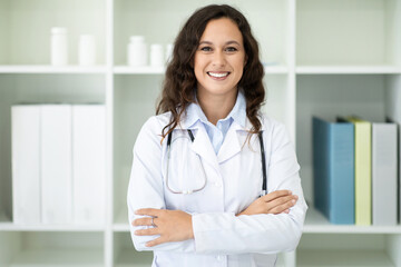 Cheerful european woman doctor posing at clinic