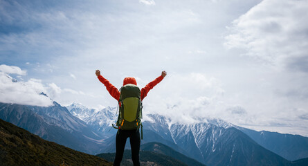 Woman hiker hiking on high altitude mountains