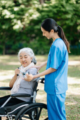 Asian physiotherapist helping elderly woman patient stretching arm during exercise correct with...
