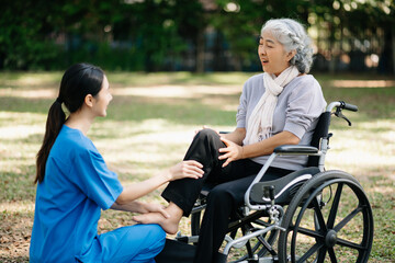 Asian physiotherapist helping elderly woman patient stretching arm during exercise correct with dumbbell in hand during training hand with patient Back problems in the garden.
