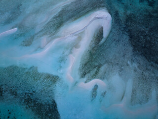 Seen from a bird's eye view, sand on a reef flat encroaches on a coral reef in the Dampier Strait of Raja Ampat. This region supports the greatest marine biodiversity on the planet.