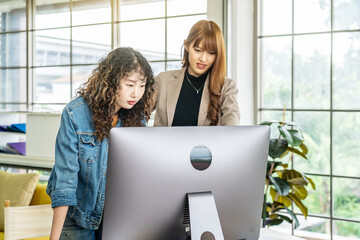 Collaboration of graphic design business people with computer in an office company, Two corporate women in creative marketing team working on project management