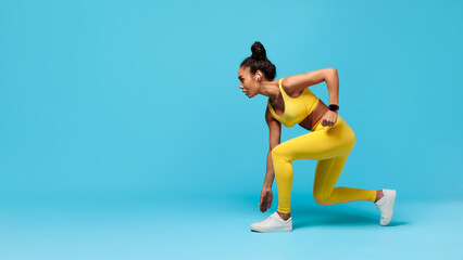 Fototapeta na wymiar African American Woman Runner Doing Crouch Start Over Blue Background