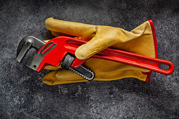 Monkey Wrench On Yellow Working Gloves.