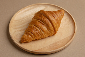 Croissants on a wooden plate