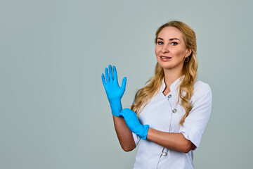 a female doctor in a white coat and blue gloves