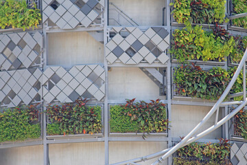 Metal framing on the exterior of a concrete wall. With vertical plantings. Close up of WestConnex,...