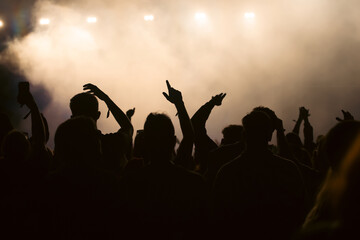 Abstract photo of crowd at concert and blurred stage lights.