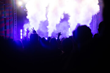 Abstract photo of crowd at concert and blurred stage lights.