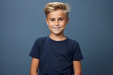 Portrait of a cute little boy with blond hair on blue background