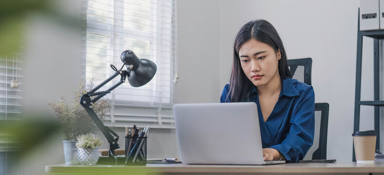 Puzzled confused asian woman thinking hard concerned about online problem solution looking at laptop screen, worried serious asian businesswoman focused on solving difficult work computer task