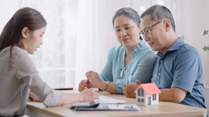 female realtor make property offer for sale to elderly spouses old customers contract on table,buy...