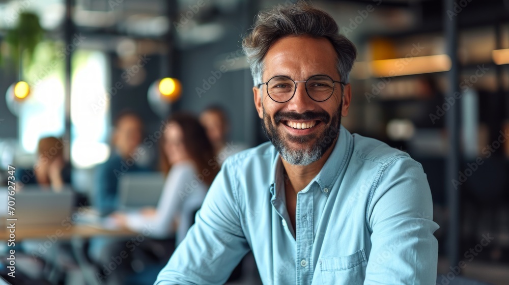 Poster Photo concept of a man in a professional office environment, smiling warmly while engaging in a discussion with colleagues Generative AI