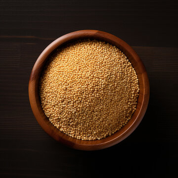 Browntop Millet (Korale) in a Wooden Bowl on White Background