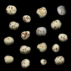 Organic Indian makhane puffed lotus seed Fox nuts isolated over black background.