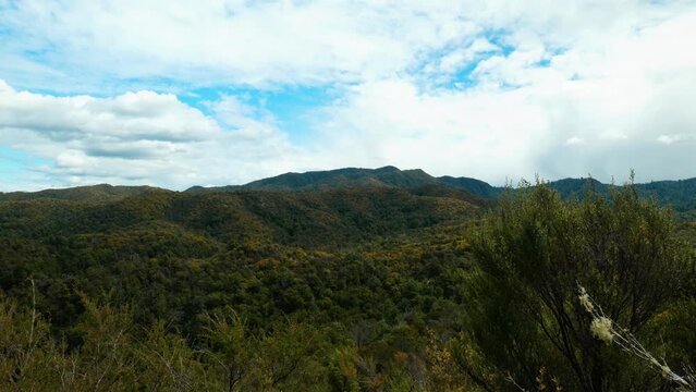 Abel Tasman allure: Clouds converge on a mountain in captivating stock footage. Nature's majestic embrace unfolds.