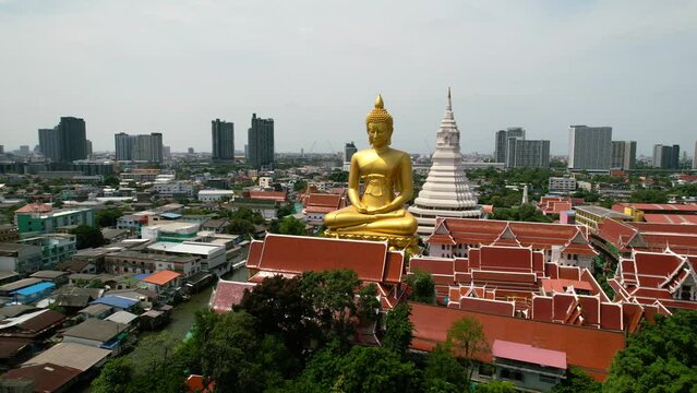 Golden Buddha Statue Wat Paknam Bhasicharoen in Phasi Charoen Old District in Bangkok, Thailand - aerial parallax