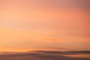 A beautiful sky tinted by the sun leaving vibrant shades of gold, pink, blue and multicolored. Clouds in the twilight evening and morning sky. Cloudy sky background in the evening and during the day.