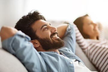Portrait of relaxed young indian man relaxing at home - obrazy, fototapety, plakaty