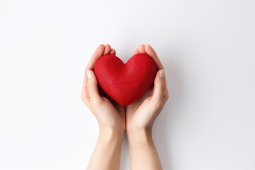 Close-up of a woman holding a red heart in her hands. Top view. Valentine's Day Card.