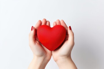 Close-up of a woman holding a red heart in her hands. Top view. Valentine's Day Card.