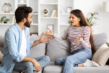 Angry emotional indian couple fighting at home