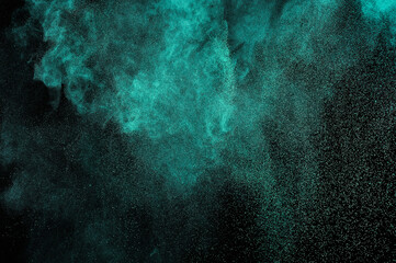 Fototapeta na wymiar Aquamarine powder explosion on black background. Colored powder cloud. Colorful dust explode. Freeze motion paint Holi.